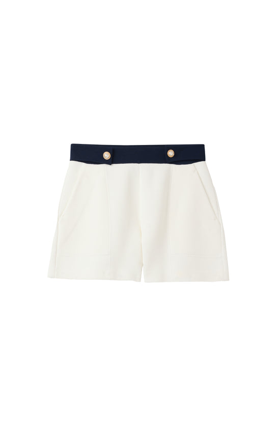 White St John Knits Malbon shorts with a navy waistband on a white background
