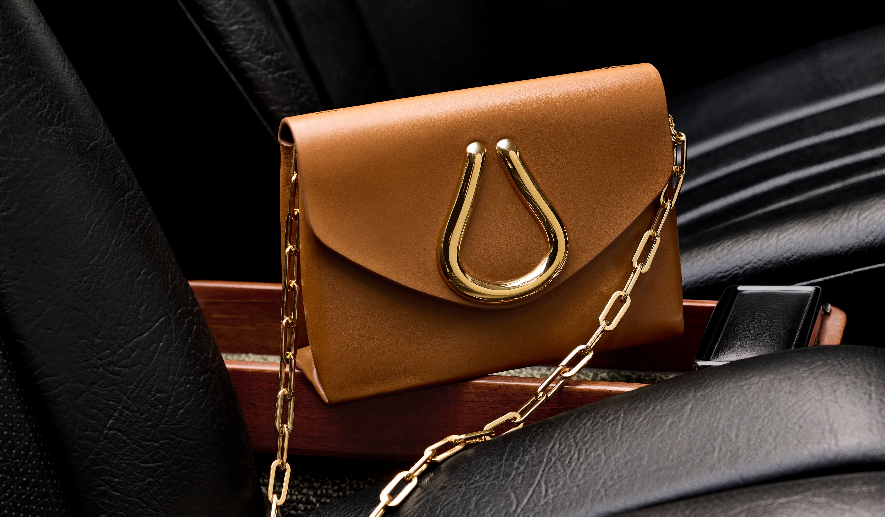 Tan St John Knits handbag with gold chain strap.